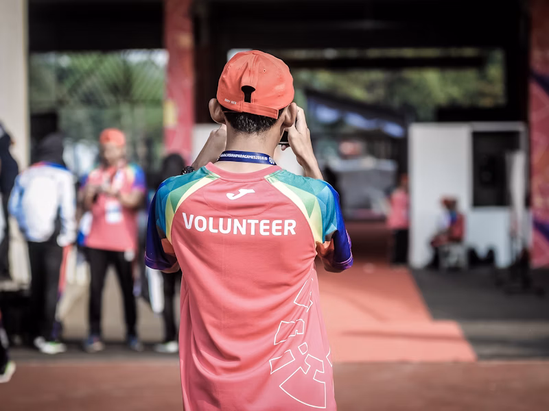 Volunteers helping disabled individuals